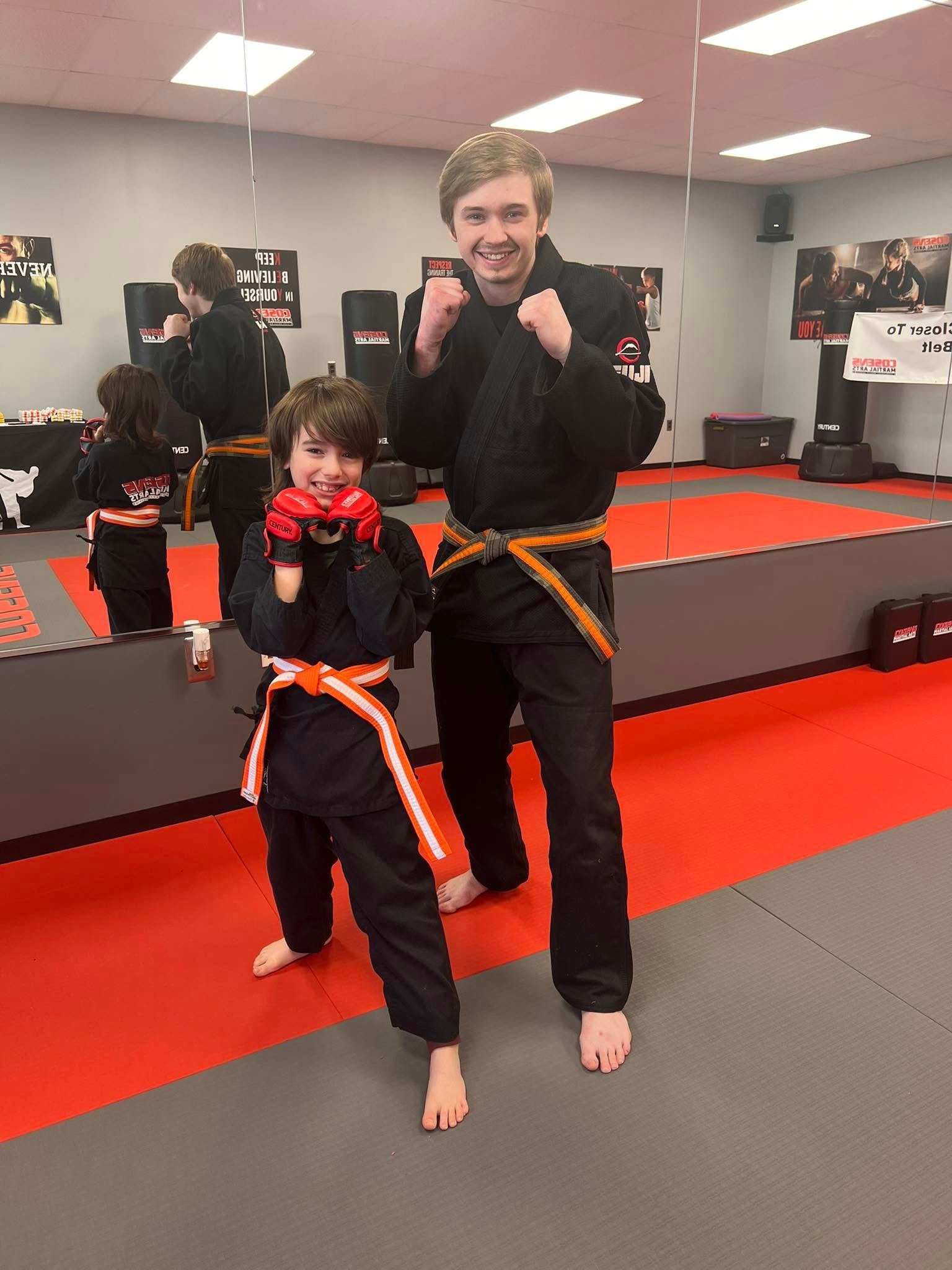 Smiling Little Ninja student with instructor at Cosens Martial Arts Fenton